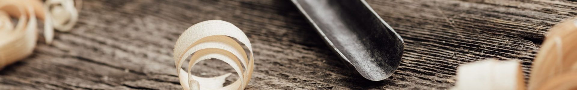 Carpenter's old workbench: gouge and wood shavings close up, woodworking and DIY concept
